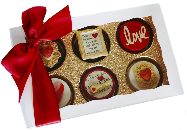 Image of white gift box wrapped with a red satin bow containing gorgeous personalized Valentine's Day chocolate covered Oreos® from Benedict Treats
