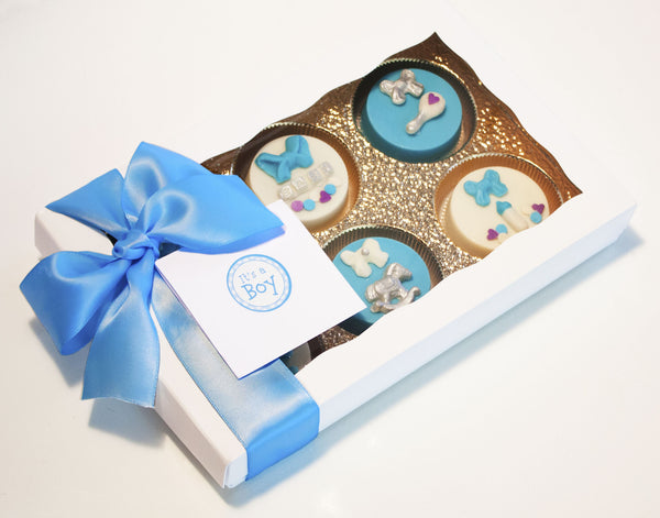 Image of a nice white gift box with a blue satin bow that contains chocolate covered oreos® as a baby boy gift from Benedict Treats