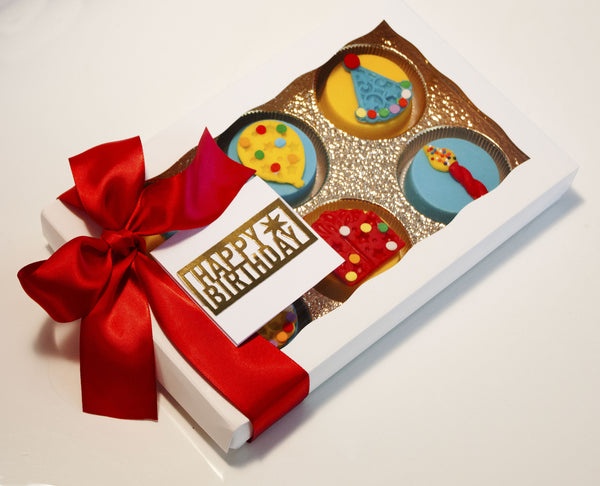 Image of a birthday gift in a white gift box with a red satin that contains candy coated birthday oreos® from Benedict Treats